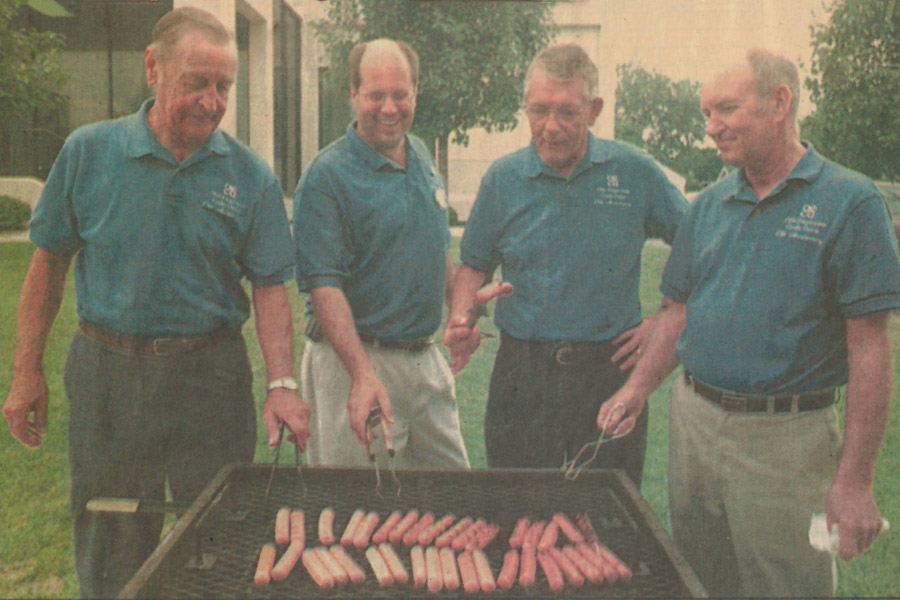 Newspaper Photo of Directors Grilling Hotdogs